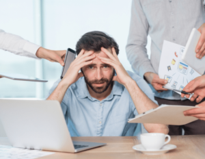 man overwhelmed with workload