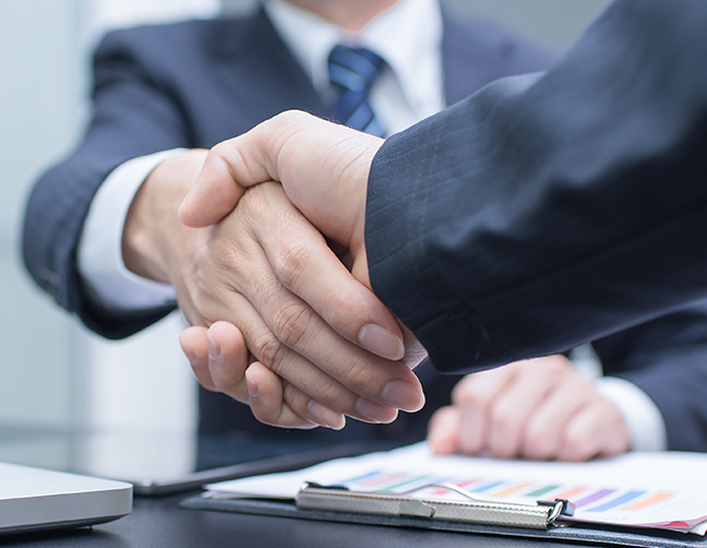 two people shaking hands after buying a business