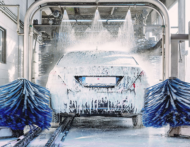 car covered in soap in car wash line