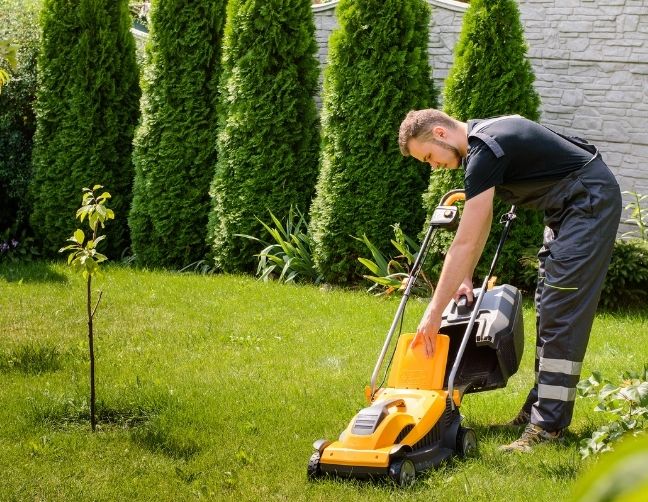 owner checks equipment before selling a lawn care business in charlotte, nc